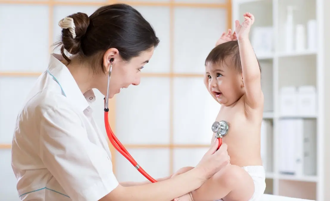 seo for pediatricians: pediatrician checking up baby.